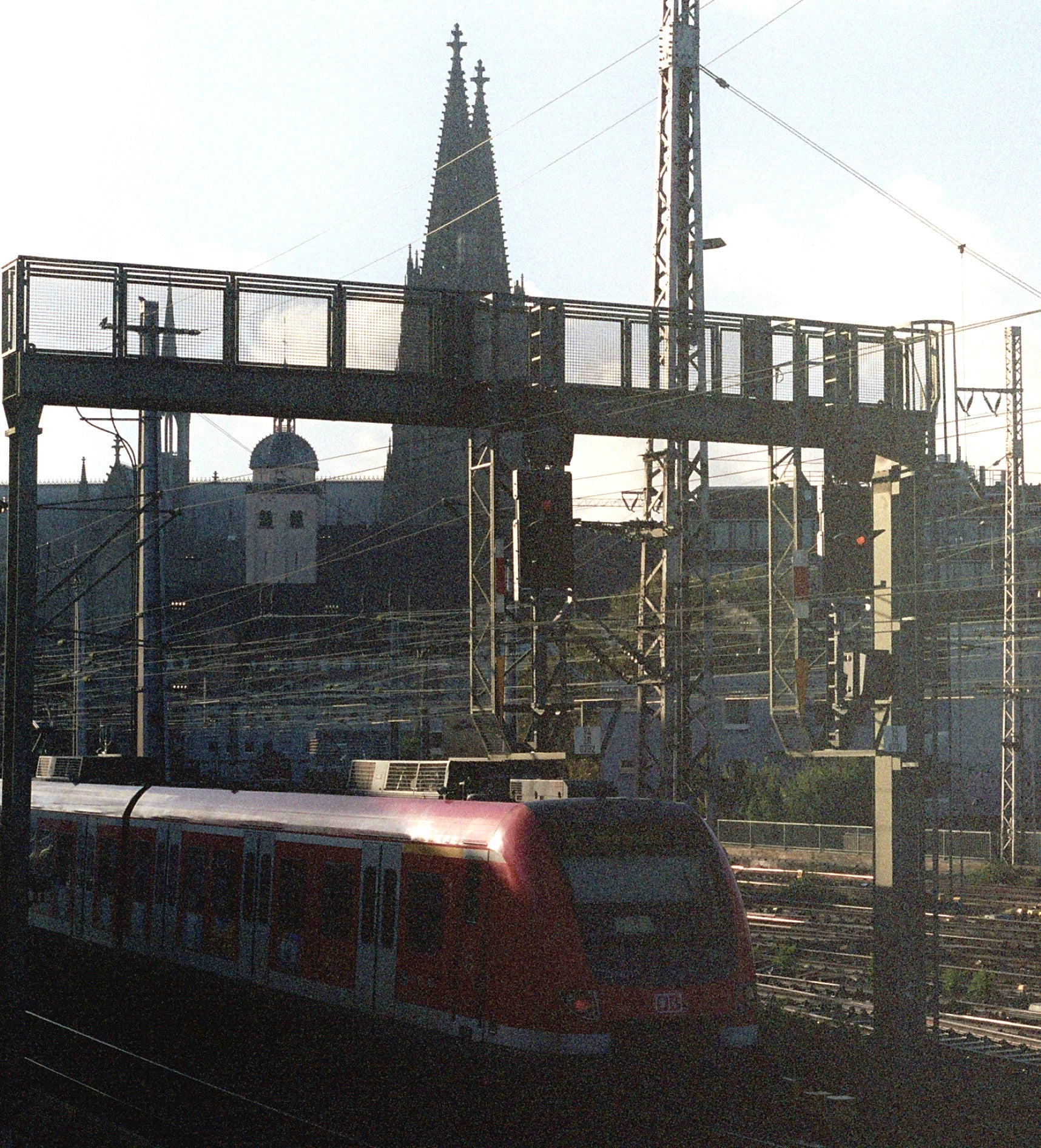 Train passing with the Cologne cathedral spire in the background. 